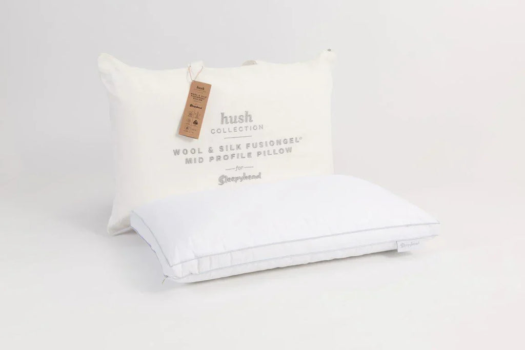 White pillow with Sleepyhead Hush Collection branding on a studio background