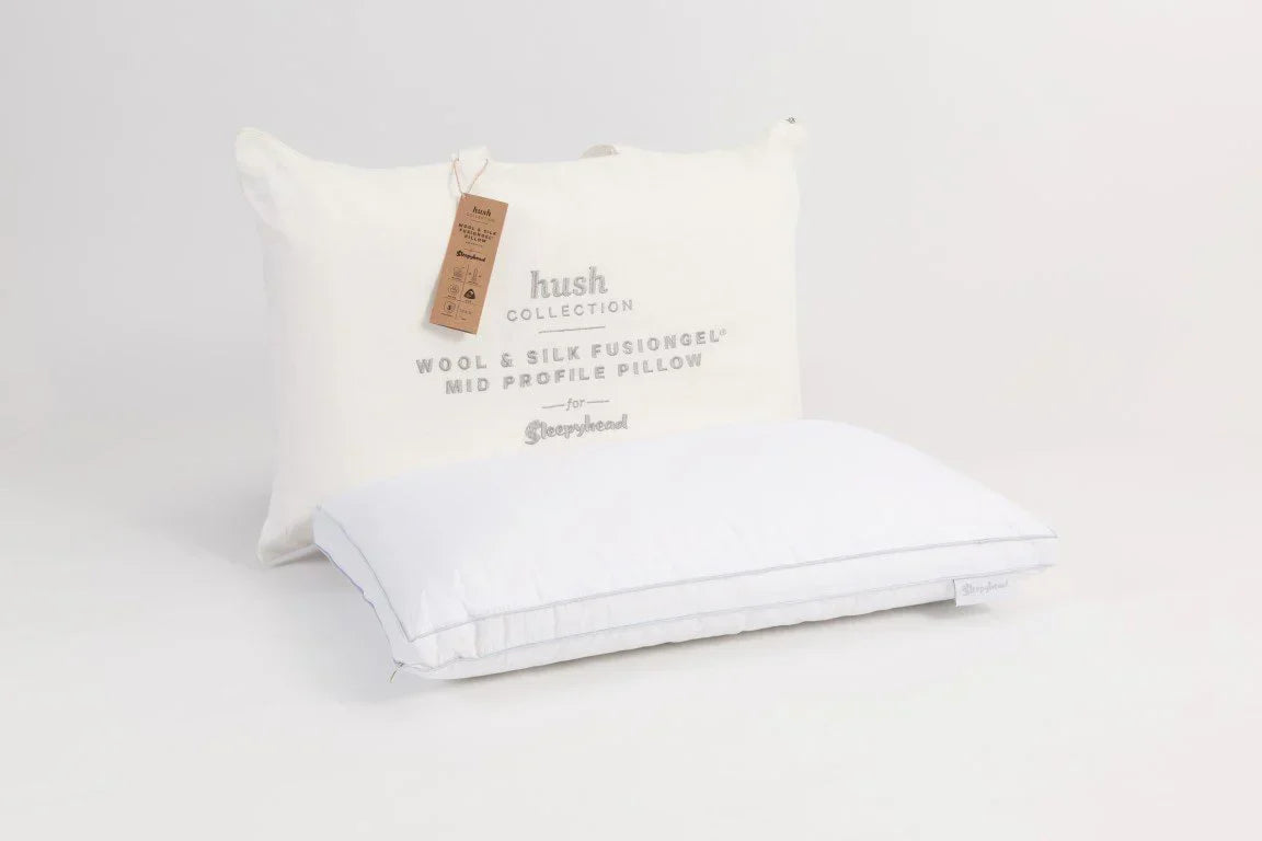 White pillow with Sleepyhead Hush Collection branding on a studio background
