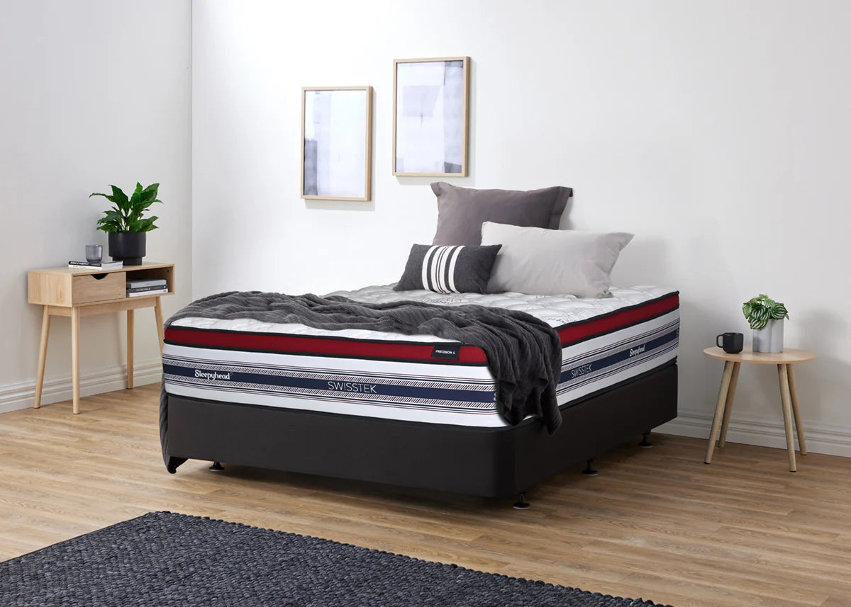 Bed with striped Sleepyhead Swisstek mattress in a bedroom setting