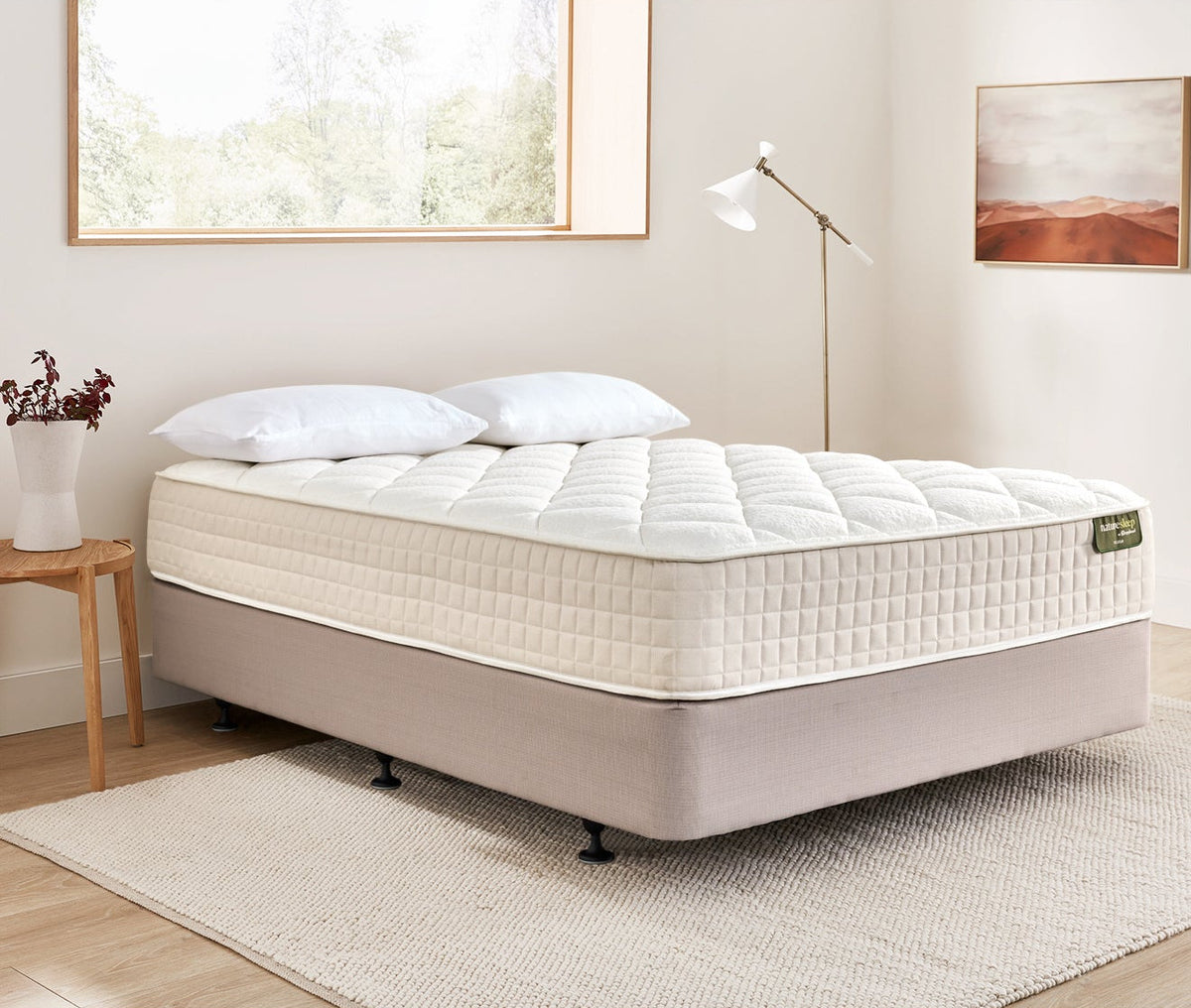 Naturesleep mattress on a bed frame in a bedroom setting