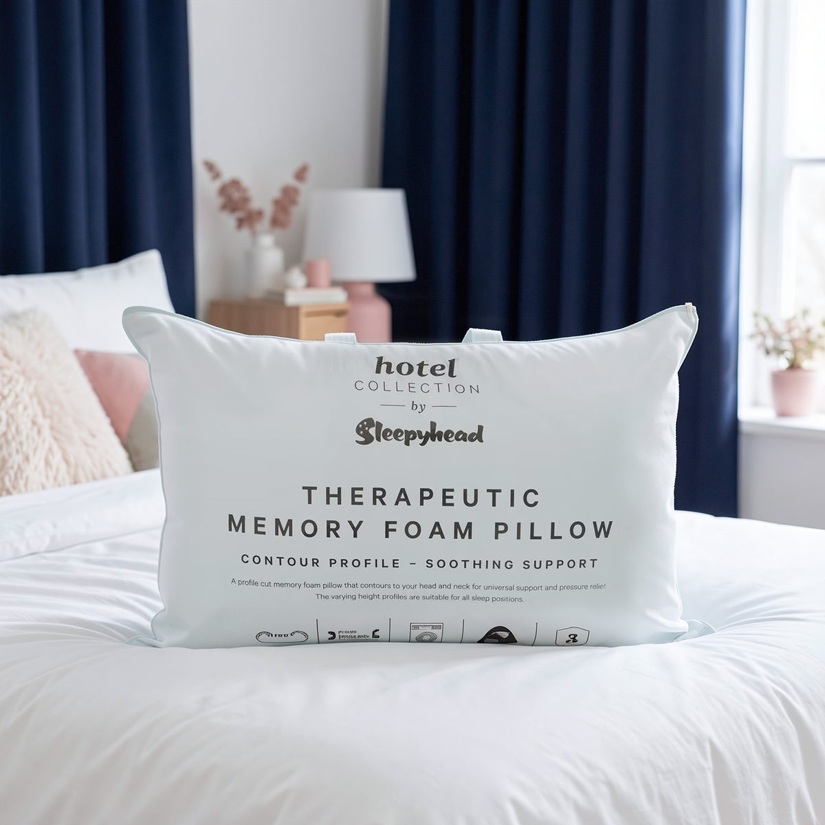 Memory foam pillow with 'Hotel Collection by Sleepyhead' branding on a bed.