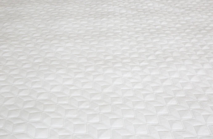 Textured white mattress topper detail