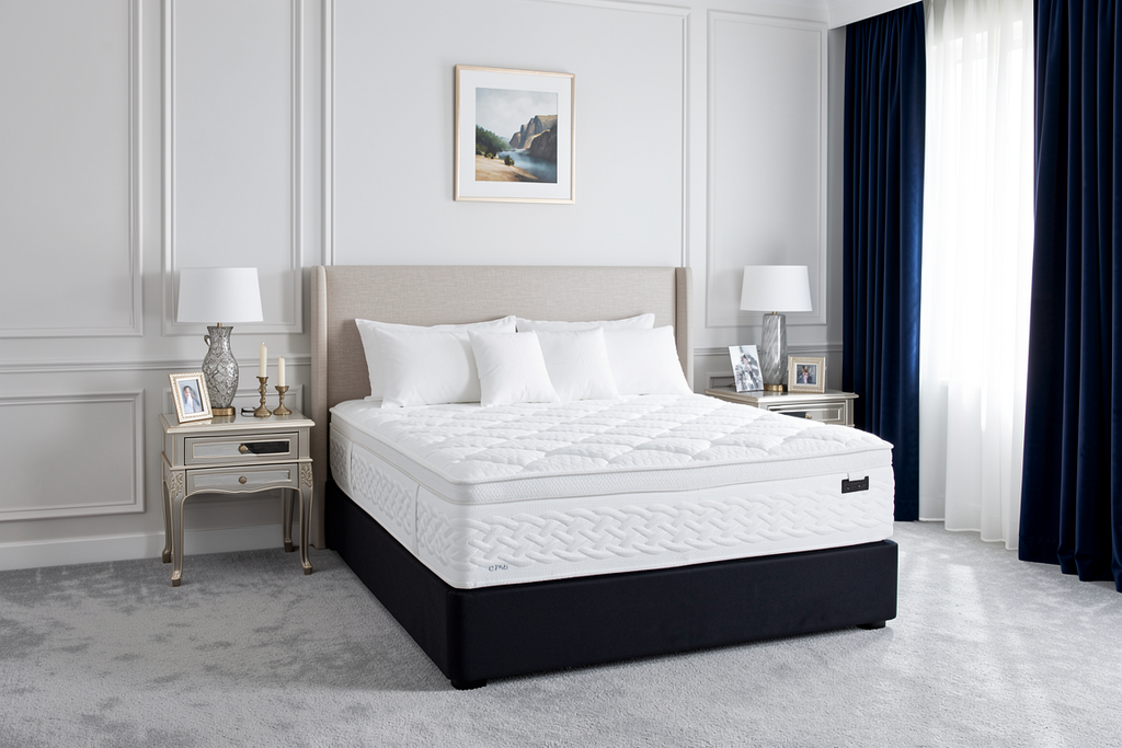 White Sleepyhead Sanctuary mattress on a bed frame in a bedroom setting with decor elements.