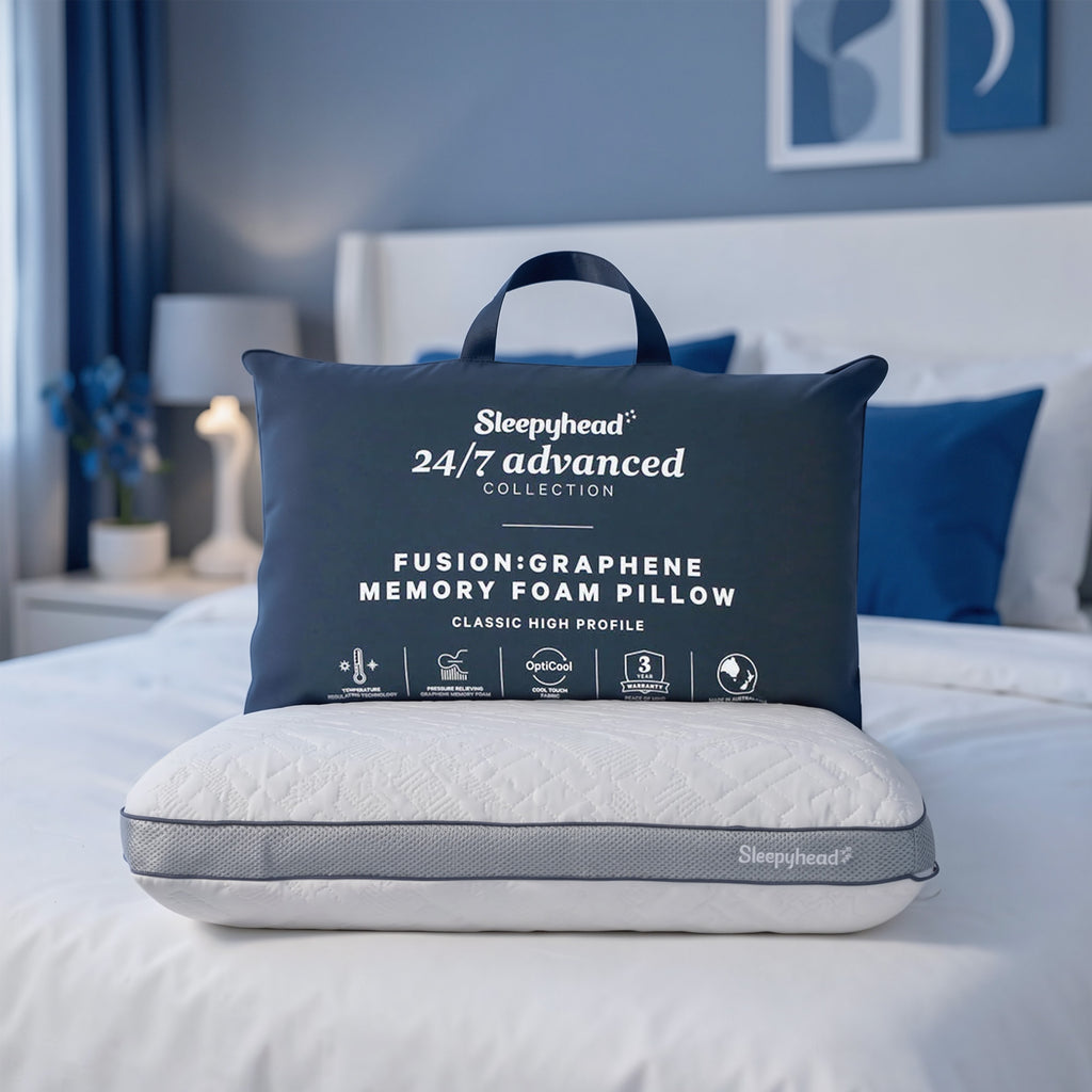 Sleepyhead Fusion:Graphene Memory Foam Pillow on a bed with packaging in the foreground