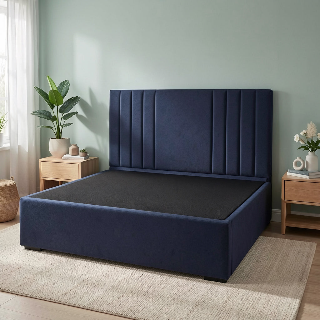 Navy blue Sanctuary bed with channel headboard in a room with light green walls and wooden furniture.