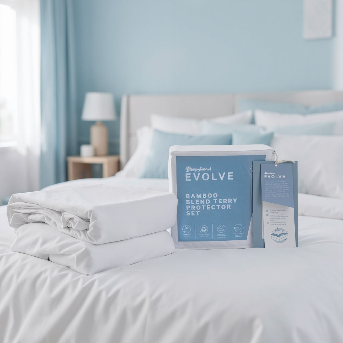 Bamboo blend terry protector set on a bed with 'Sleepyhead Evolve' packaging.