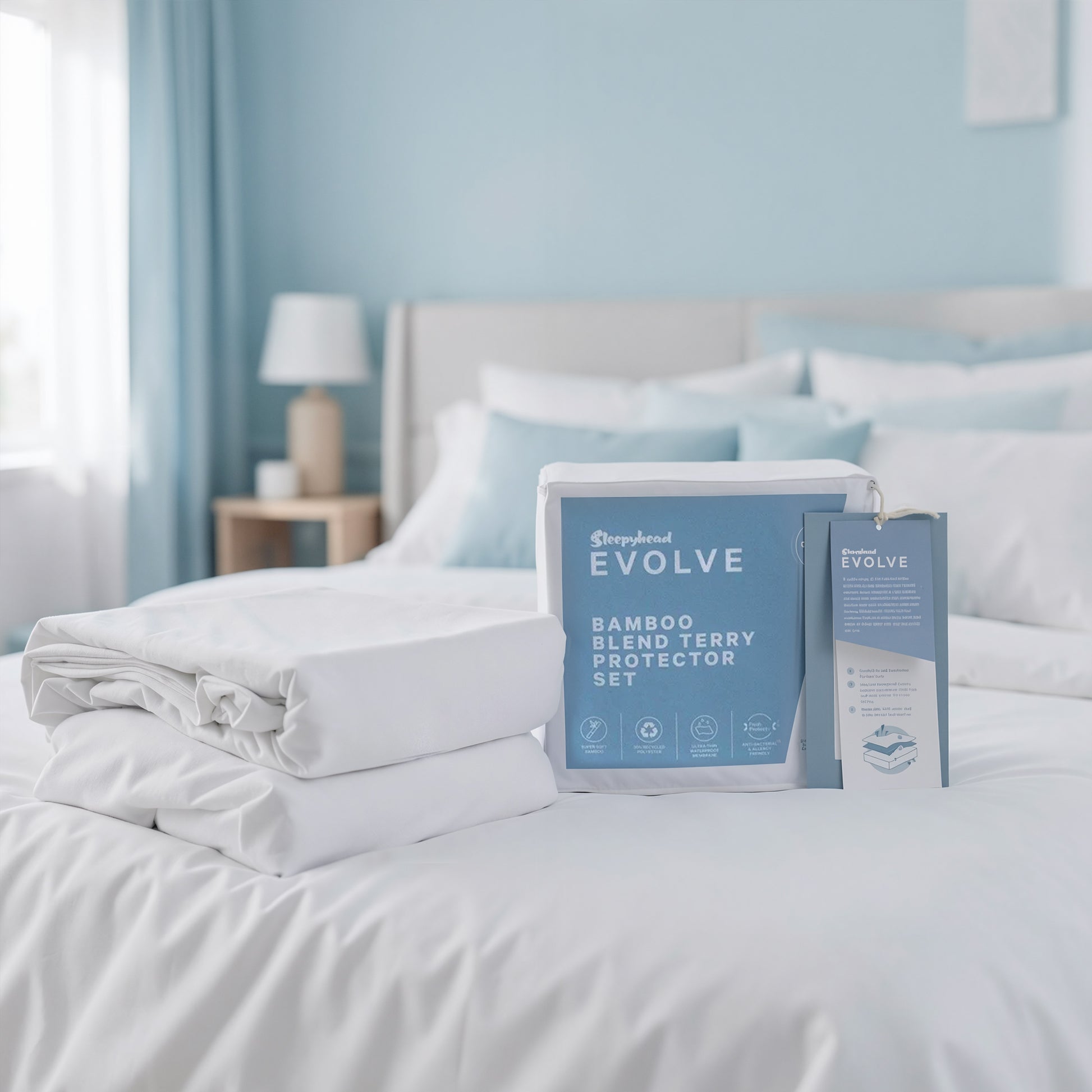 Bamboo blend terry protector set on a bed with 'Sleepyhead Evolve' packaging.