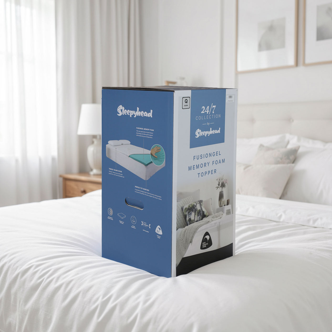 A Sleepyhead memory foam mattress topper box sitting on a bed