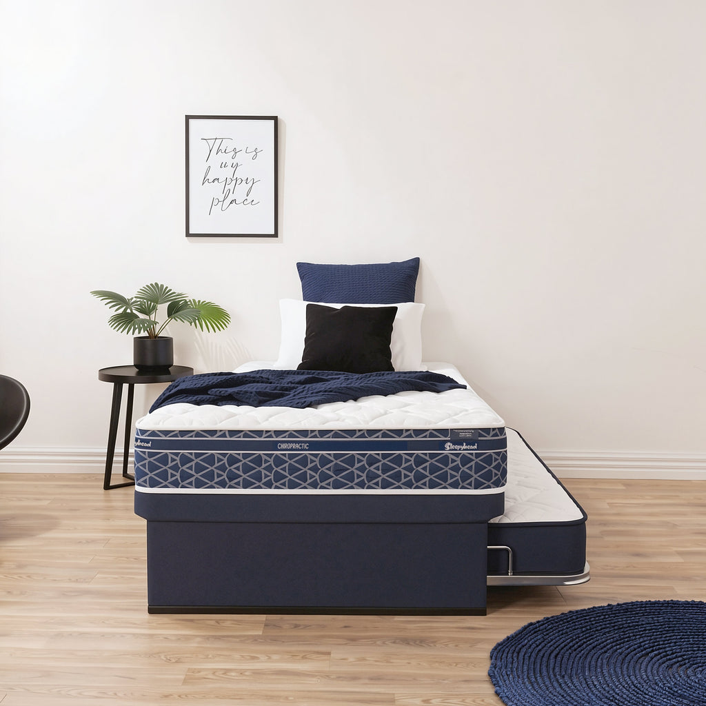 Sleepyhead Chiropractic trundler bed base and popup mattress on a bedroom setting.