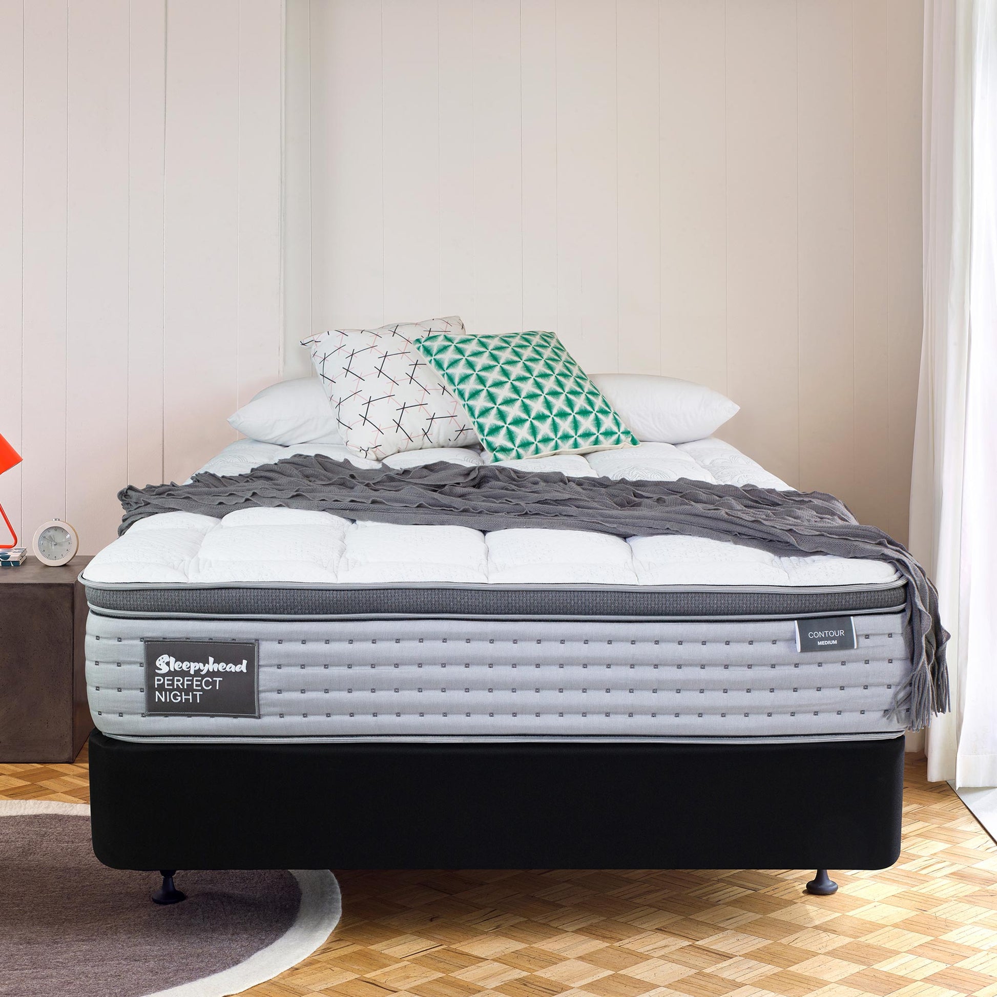 Bed with a mattress labeled 'Sleepyhead Perfect Night' in a bedroom setting.