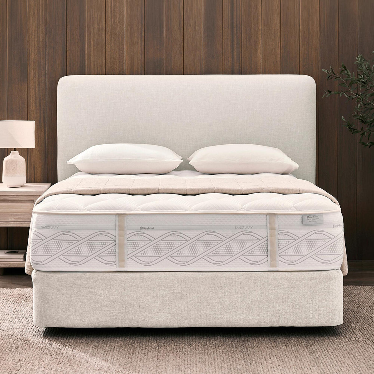 Sleepyhead Sanctuary mattress with a base and a headboard, with pillows in a bedroom setting