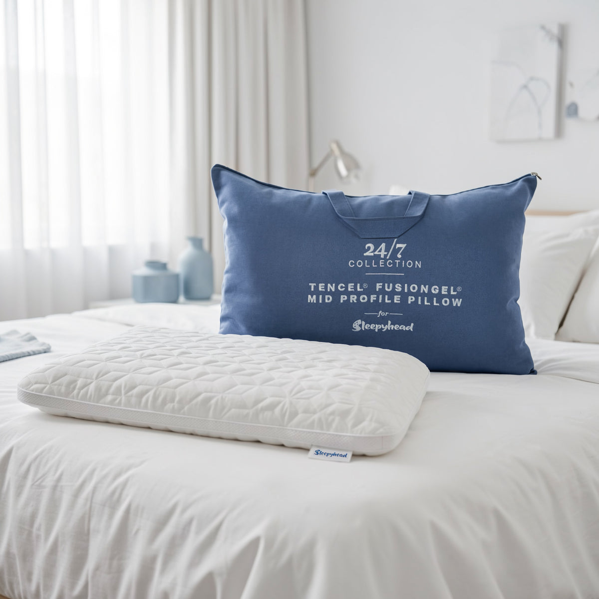 Blue Sleepyhead Tencel FusionGel pillow on a bed in a bedroom setting