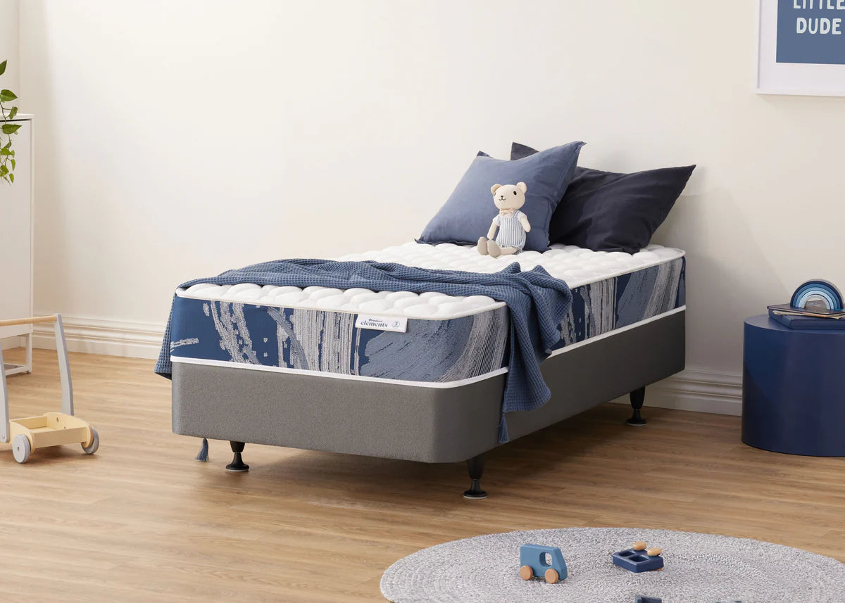 Children's Sleepyhead Elements bed with blue bedding and a teddy bear in a room setting.