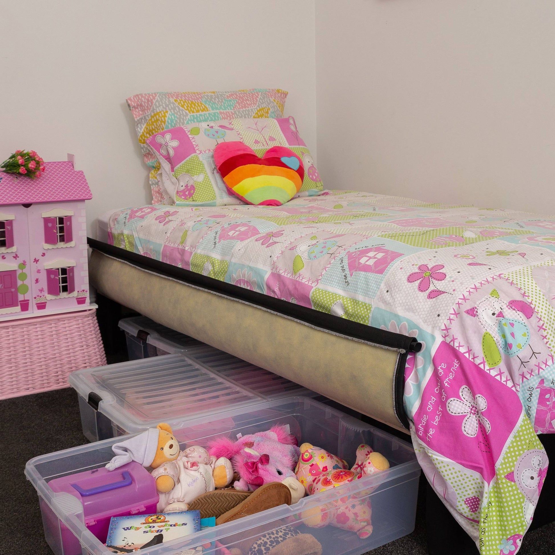 Children's bedroom with a Sleepyhead Spacebase bed with colorful bedding, toys, and a dollhouse.